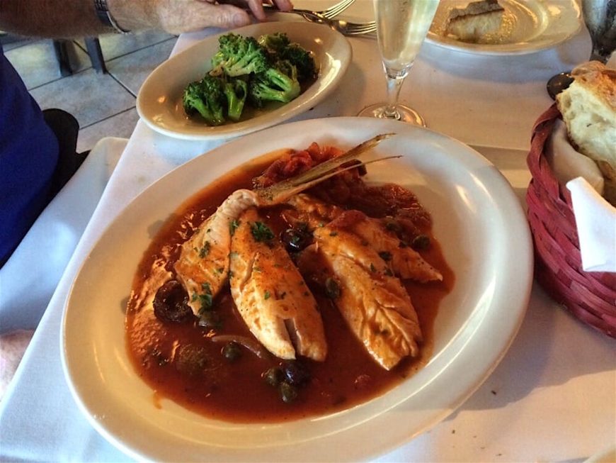 Snapper Livornese simmered in a hearty tomato sauce with onions, capers, black olives, diced tomatoes & parsley